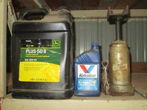 John Deere oil and a bottle jack