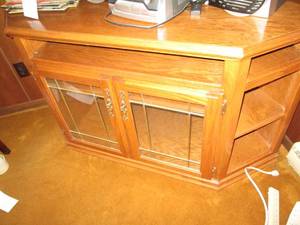 Wood entertainment center with glas...