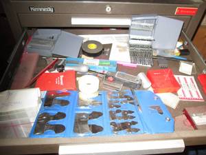 Machinist measuring and cutting too...