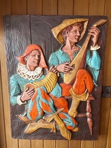 This vintage mid-century modern 3D wall sculpture, titled Jesters and Clowns or Renaissance Minstrels, is a fiberglass art piece by the artist J. Segura