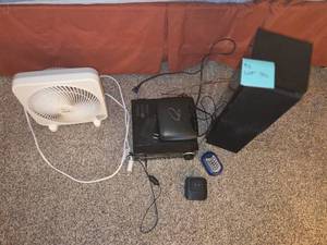 Assortment of electronic devices- DVD player wspeakers, small fan, router, etc...