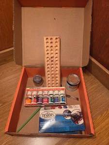 Box of art supplies including paint