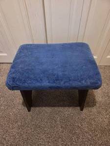 Vintage wooden footrest with blue cushioned top