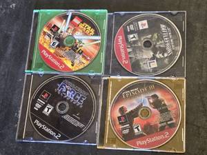 Star Wars PlayStation 2 Game Lot including The Force Unleashed, Lego Star Wars, Episode III Revenge of the Sith, and Battlefront