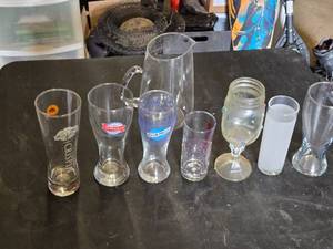 Variety of Glassware and Pitcher Collection Including Bubba Gump and Blue Moon Glasses