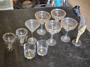 Various Glasses, Some Plastic and Goblets Including Skeleton Hand Stand and Bullet Embedded Tumblers