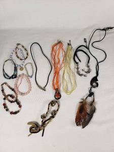 Lot of Jewelry Including Feather Necklace, Beaded Bracelets, and Decorative Pendants