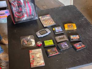 Assorted Video Games, Console, and Accessories Lot including VR Real Feel Racing, Game Boy Advance, and Sega Genesis Cartridges