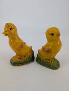 Pair of Yellow Duck Figurines on Leaf-Textured Green Bases