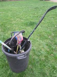 Rubbermaid trash can containing hoc...