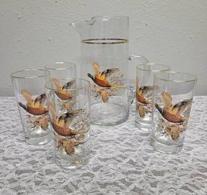 Pitcher with 5 glasses.  These items are likely produced by the West Virginia Glass likely from the mid-century era, featuring a distinctive pheasant-in-flight design with gold rim embellishments.&nbsp&nbsp