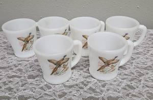 Six Vintage Anchor Hocking Fire-King milk glass mugs featuring the Ring-Necked Pheasant pattern.  These mugs were produced primarily between 1959-1962.&nbsp