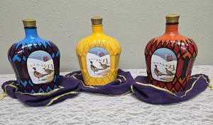 Three upcycled Crown Royal whiskey decanters that appear to be hand painted and decoupaged. The bottles come with Crown Royal velvet bags.The artist signature is Bickford that appears on the decanter.&nbsp;&nbsp;