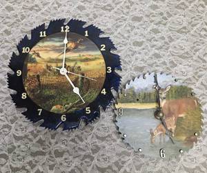 Two sawblade painted clocks.  The clock edged in black works (has new batteries) the other does not.&nbsp&nbsp