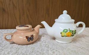 &nbspVINTAGE-Two ceramic teapots one with flowers and the other butterflies.&nbsp&nbsp