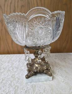 Vintage cut crystal pedestal centerpiece bowl for fruitcandy. Features a decorative metal stand with dangling prisms. Often categorized as Hollywood Regency or 19th Century style. Approx. 10 tall.&nbsp&nbsp