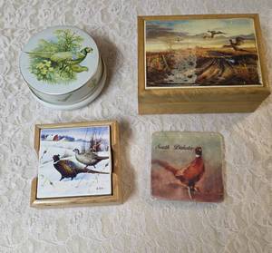 One- Riley Brothers Toffee Tine, Four-Pheasant Coasters in holder, One-Pheasant Coaster that says South Dakota on it, One- Velvet lined box. The picture on the front of the box appears the deco has lifted.&nbsp&nbsp