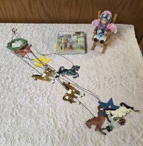 One - Horse windchimemobile, One-bag of Cocktail napkins, One-bisque porcelain doll featuring a matte, realistic finish on its head, hands, and feet, and soft cloth body seated in a wooden rocking chair.&nbsp&nbsp