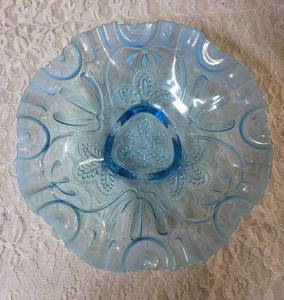 Vintage blue opalescent glass bowl, likely produced by the Jefferson Glass Company (Northwood Glass Co - in early 1900s) in the Meander pattern.  It is a footed bowl with three feet with a crimped or ruffled rim.&nbsp