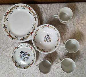 Four piece setting of Home Essentials Woodland Celebration dinnerware set.  Featuring snowman and holly branch patterns.&nbsp&nbsp