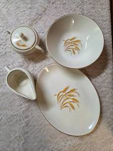 Vintage Homer Laughlin Golden Wheat set that includes a serving dish, serving bowl, sugar bowl and creamer. This set  likely produced in the 1950s with wheat stalk design and 22k gold trim.&nbsp&nbsp