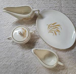Vintage Homer Laughlin Golden Wheat set that includes a serving dish, gravy bowl, sugar bowl and creamer. This set  likely produced in the 1950s with wheat stalk design and 22k gold trim.&nbsp&nbsp