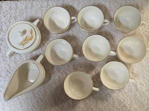 Vintage Homer Laughlin Golden Wheat set that includes a sugar bowl and creamer bowl and eight coffee cups. This set  likely produced in the 1950s with wheat stalk design and 22k gold trim.&nbsp&nbsp