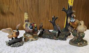Three -Vintage Resin Figurines and 1 Pheasant on  Wagon Wheel Plate Holder.&nbsp