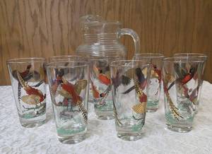 Hazel-Atlas Pitcher and  8&nbsp glasses featuring the Pheasants pattern. The pitcher is clear, ribbed glass with transferware illustrations of colorful flying pheasants, hunters and dogs.&nbsp