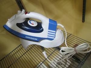 Oreck steam iron with storage holde...