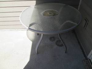 Round metal famed glass top patio t...