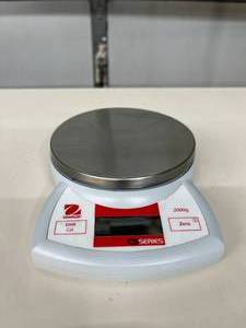 Ohaus CS2000 Scale w pan &amp adapter. A portable, easy-to-use digital scale for quick, accurate weighing. Features a stainless steel top, battery power, and simple 2-button control. Great for home kitchens, mail, or hobbies.