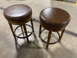 Pair of Leather Upholstered Bar Stools that spin with Wood Legs and Metal Foot Rests