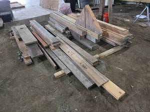 Stack of Mixed Lumber and Timber variety of lumber and timber pieces of different sizes and types, some pieces exceeding 8 feet in length