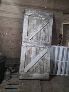 Old Wooden Barn Door with Covered in Light Tin on One Side