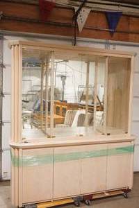 2-Piece, Mirrored Display Cabinet Hutch with Glass Shelves. Carrier, made in Canada. Light-Colored Wooden Hutch.