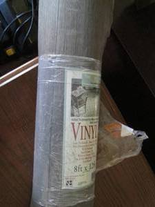 Roll of linoleum, gray wood pattern...