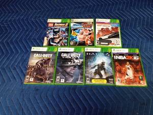 5 Xbox 360 games in cases and 2 empty cases