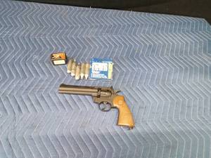 Vintage Crossman Model 357 CO2-powered pellet revolver with CO2 cartridges and pellets