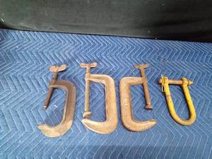3 large metal clamps and a clevis hitch