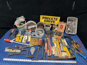 Tote of new and used hardware and tools