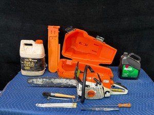 Stihl Chainsaw with approximately 2 gal bar oil and 1 gal bar oil and accessories