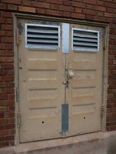 ANTIQUE METAL DOORS  BACK WLL OF BUILDING