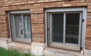 2 METAL SECURITY WINDOW COVERS  BO BUILDING