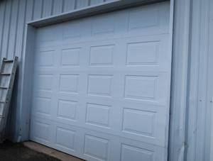 10 X9 INSULATED GARAGE DOOR WITH OPENER.