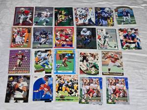 Lot of 22 Hall of Famers and Stars Football Cards Featuring Deion Sanders, Troy Aikman, Junior Seau, Joe Montana, Marshall Faulk, and Drew Bledsoe.