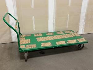 Green Platform Cart with Airport Code Labels on Wooden Deck - Industrial Trolley