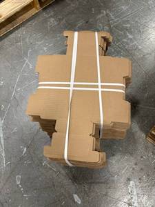 Cardboard Die-Cut Boxes Bundled in Stacks