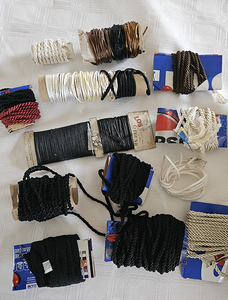 A collection of various styles and colors of trim  cording