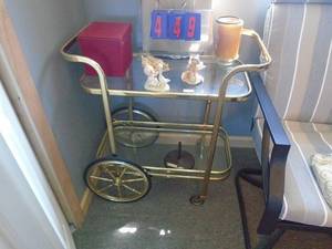 Brass & glass cart with misc figurienes. As shown.CASH ON SITE ONLY. PICKUP IS TUESDAY MAY 19TH FROM 11 AM TO 4 PM. REGARDLESS WHAT THE SCHEDULE STATES.